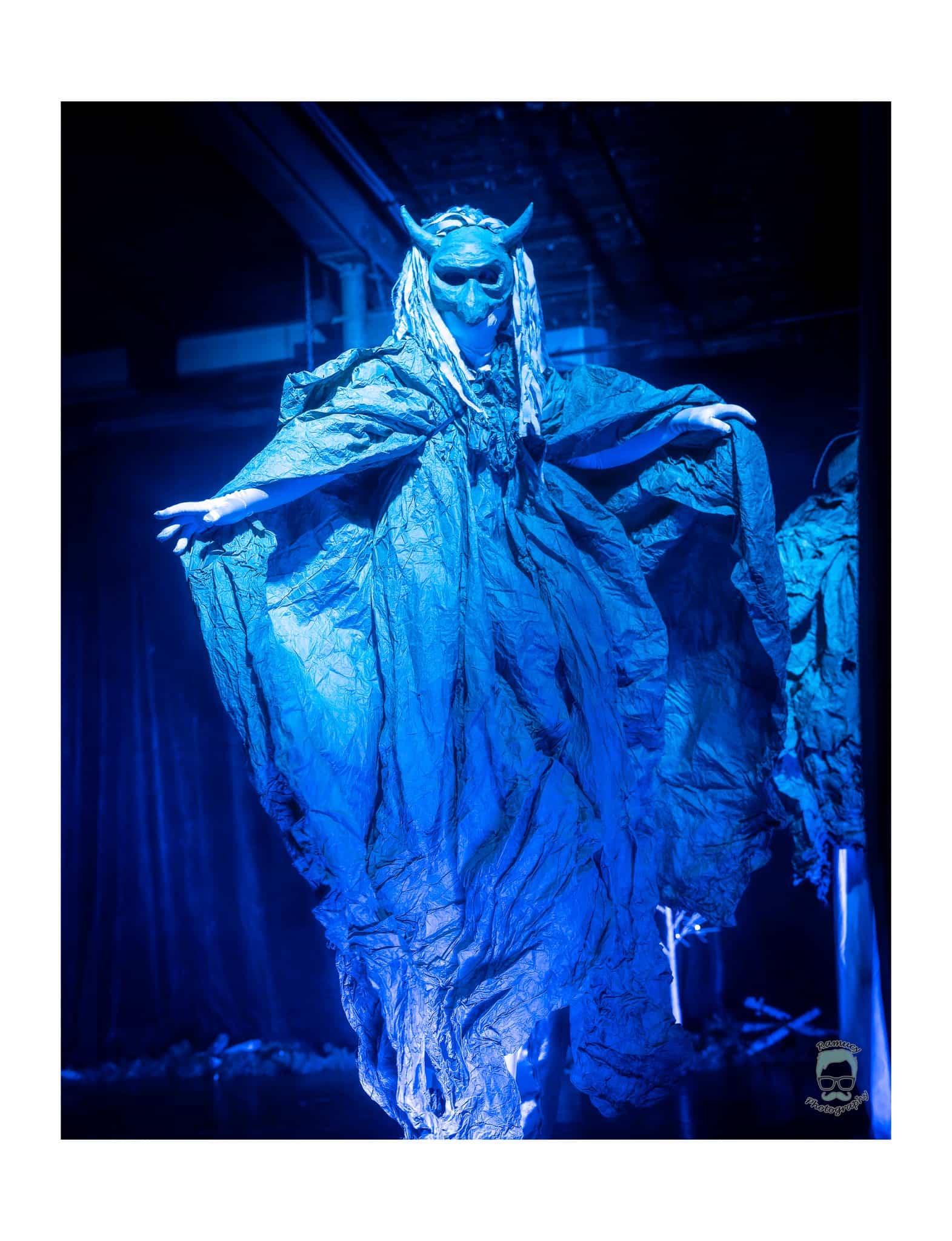 Stilter in masked costume enters at La Nuit d'Hibernation
